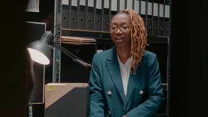 Team of law office agents reading criminal records, working in police archive with detective board...