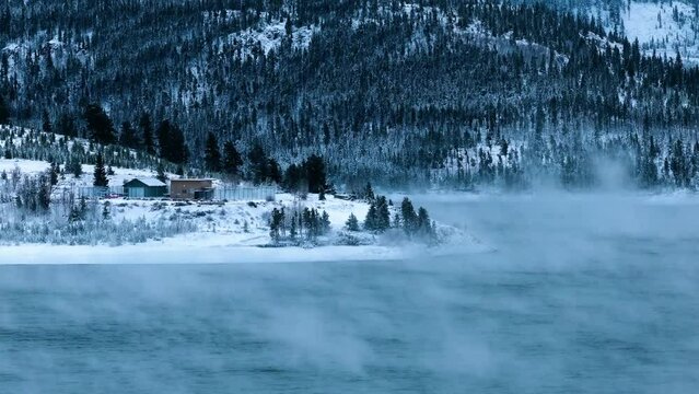 Winter lake with thick fog and snow, close up, drone video, Dillon, Colorado, 4K