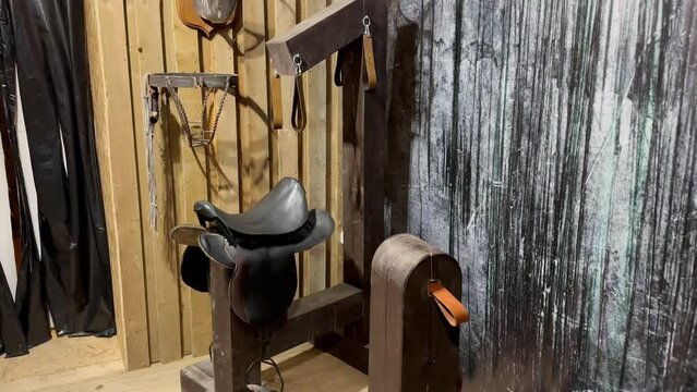 Prison room with wooden walls with medieval tools for torture and pain. Equipment for torture