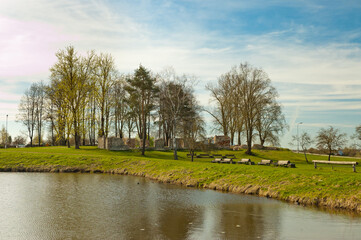 river close-up, in the photo there is a river, blue sky and green meadow