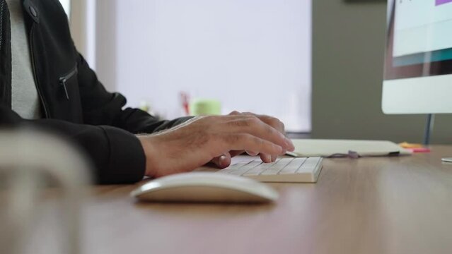 Close up of freelancer's developer hands typing program code on laptop keyboard in coworking. Businessman at work in working in office. Copywriter writing text on computer keyboard 
