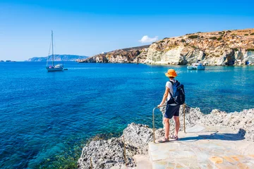 Fotobehang Young woman tourist looking at Rema beach in beautiful sea bay, Kimolos island, Cyclades, Greece © pkazmierczak