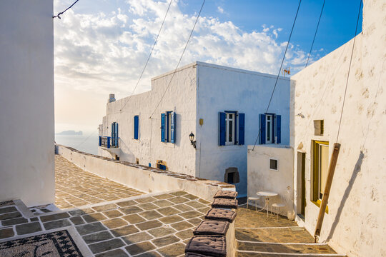 Fototapeta Narrow streets of Plaka village with traditional white houses at sunset time, Milos island, Cyclades, Greece