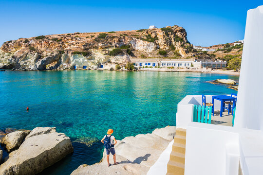 Young woman tourist looking at Rema beach in beautiful sea bay, Kimolos island, Cyclades, Greece