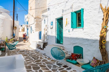 KIMOLOS ISLAND, GREECE - SEP 26, 2023: shop located in narrow street with typical Greek style architecture in Kimolos village, Kimolos island, Cyclades, Greece.