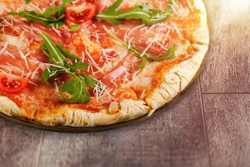 Tasty fresh hot pizza dish on desk
