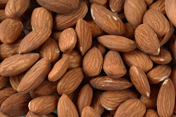 Dried almonds. Almond background. A pile of dry nuts