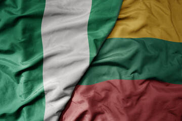 big waving national colorful flag of lithuania and national flag of nigeria .