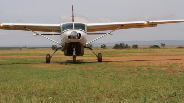 Small plane approaching camera in Kenya field