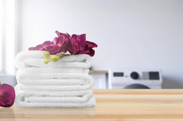Obraz na płótnie Canvas Clean laundry on table in cozy bathroom