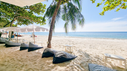 beach chairs sunbed with umbrellas at the white tropical beach of Samed Island with a turqouse...