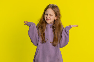 What. Why. Young redhead school girl raising hands in indignant expression, asking why, what reason of failure, demonstrating disbelief irritation by troubles. Preteen child kid on yellow background - obrazy, fototapety, plakaty