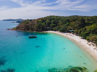 a tropical bay from above at Koh Samet Island Thailand, aerial drone view from above at the Samed Island in Thailand with a turqouse colored ocean and a white tropical beach from above drone view