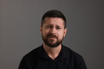 Fototapeta premium Personality concept. Emotional man on grey background