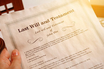 Woman holding Last Will and Testament at table, closeup - obrazy, fototapety, plakaty