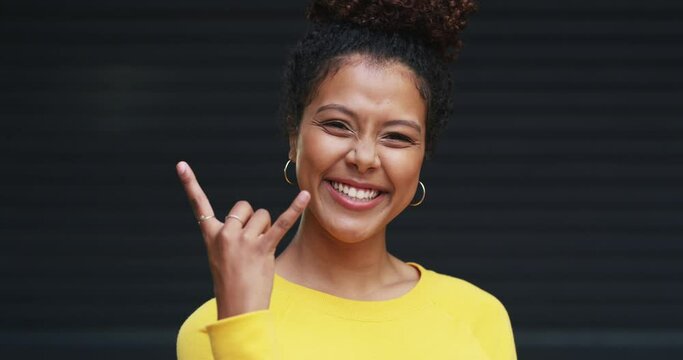 Face, rock on and woman with a smile, excited and freedom with support, culture and hand gesture. Portrait, person and model with sign, good mood and vibes with energy, rockstar and emoji with icon