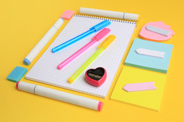 Different school stationery on yellow background. Back to school