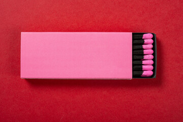 top view pink matchbox on a red background