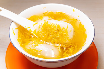 angle view bowl of Chrysanthemum Glutinous Rice Balls at horizontal composition