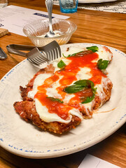 Chicken parmesan with cheese and tomato