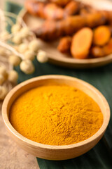 Turmeric powder and fresh turmeric in wooden bowl, Spice in Asian cuisine