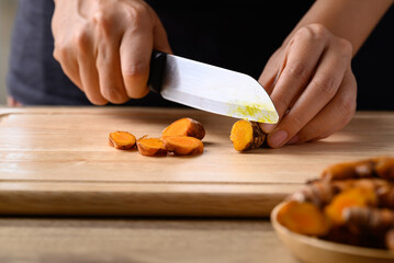 Fresh turmeric cutting on wooden board prepare for Asian cuisine cooking