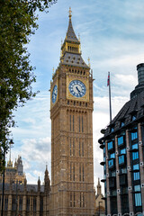 Fototapeta na wymiar Low angle of aged building of famous Big Ben against clock tower located on street of London against blue sky background