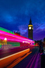 Fototapeta na wymiar Exterior of historic buildings with glowing lights located against Big Ben tower at night in London city