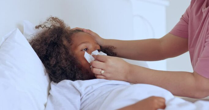 Cold, mother and girl child with tissue to wipe nose or monitor wellness on bed in bedroom of home. Healthcare, woman or hands for medical support, sick or care for ill kid with flu, fever or virus