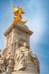 Fototapeta na wymiar From below of Queen Victoria Memorial monument located at the end of The Mall in front of The Buckingham Palace under cloudy blue sky in Westminster, London