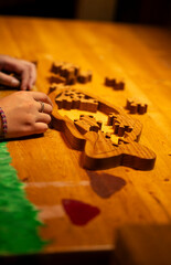 a kid playing with a wooden puzzle