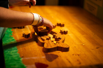 a kid playing with a wooden puzzle