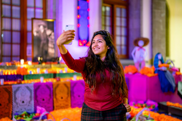 Smiling young Latin woman tourist in casual clothes with dark long hair taking selfie with...