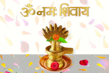 golden metal shivalinga idol with text Om Namah Shivaya meaning adoration to lord Shiva hindu...