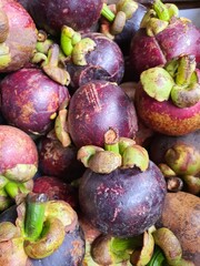 Close up pile of tasty fresh mangosteen sold at the market as a background.