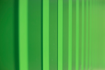 Green fence. Fence in detail. Ribbed steel.