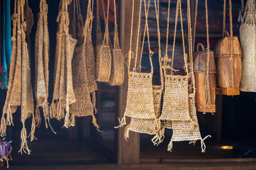 various items are hung made from rattan, leather and thread to form bags, totes and various...