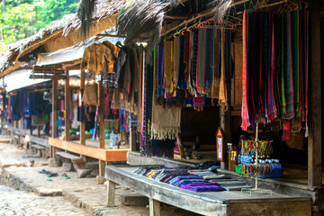 
various kinds of traditional merchandise in outer Baduy that are there in the form of bags, key chains, clothes, sarongs and so on - obrazy, fototapety, plakaty