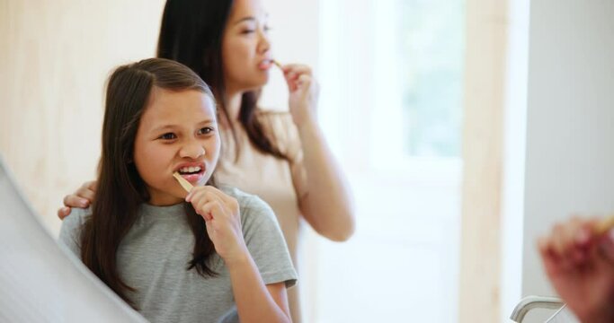 Mother, girl and brushing teeth in morning routine, mirror and playful in bathroom, hygiene and wellness. Dental care, oral health and toothbrush with toothpaste for plaque, cleaning and whitening