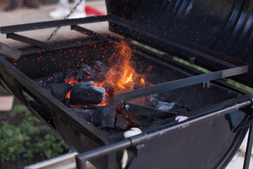 Photograph of charcoal grill ignited. Food preparation concept.