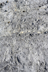 Roughly textured medium gray rock, as a nature background
