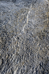 Roughly textured medium gray rock, as a nature background
