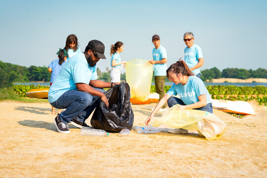 group of diverse people,environmental conservation activist keeping plastics waste by the river,volunteers,plastic waste,environmental conservation