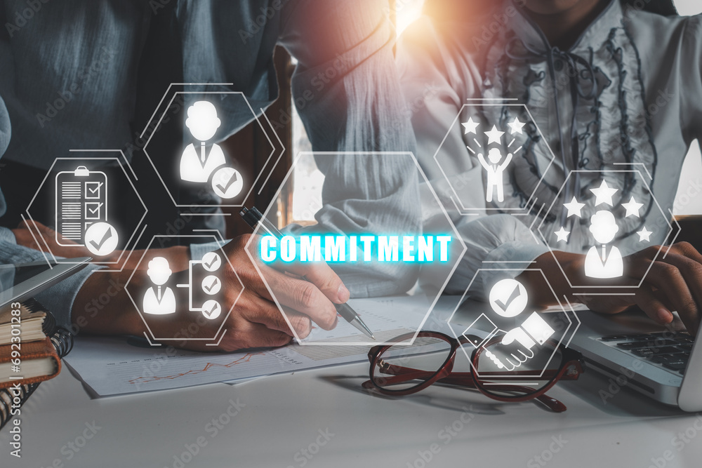 Poster commitment concept, business team analyzing income charts and graphs on office desk with commitment 