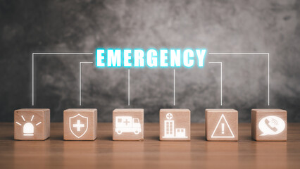 Emergency concept, Wooden block on desk with emaergency icon on virtual screen.