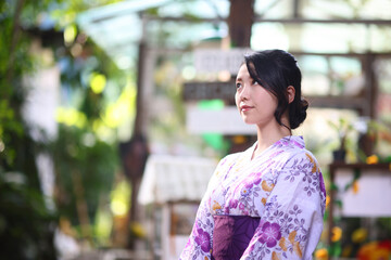 Japanese woman in yukata in green park