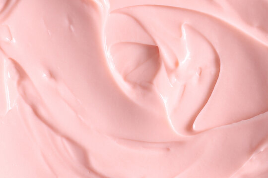 Pink skin care cosmetic beauty cream texture background in close up