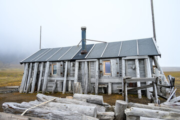 Old, historic, rustic trappers cabin at Bamsebu, Svalbard, Arctic, polar adventure travel and...