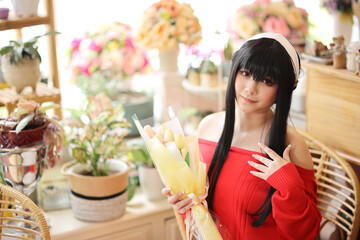 Portrait of a beautiful young woman Cosplay with red sweater at flower shop