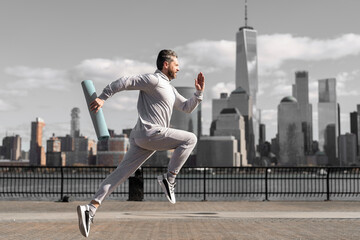 Man in sports suit training jogging. Running man in Manhattan. Morning sport workout jogger run in New York. Jogger run at sport training. Sportsman jogger running or jogging. Personal achievement